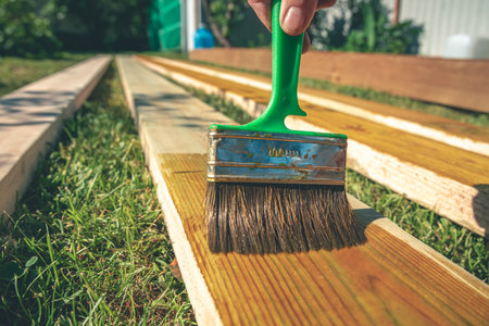 coating wooden boards with an antiseptic with a brush. constructionの写真素材
