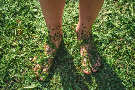The concept of summer, ecology. unity with nature. bare feet in the grassの写真素材