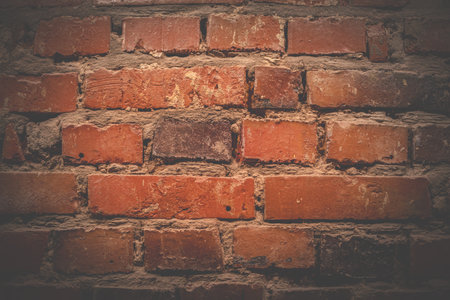 Red brick wall. Texture of old brown and red brick wall background. Fragment of red brick wall closeup. The structure of the background. Template for an inscription. Mockup for designs.の写真素材