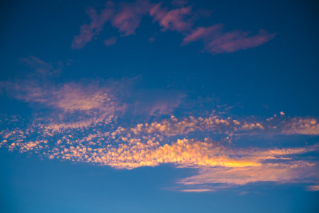 Beautiful unusual clouds in the sky at sunset. Sunlight