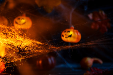 Halloween. crawl spiders on the web. Garland with orange pumpkinsの写真素材