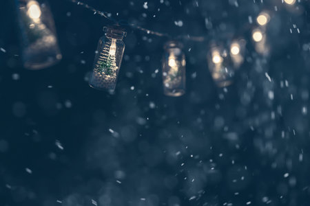 Christmas garlands with Christmas trees in bottles on a dark blue background. New Year, Christmas, winter backgroundの写真素材
