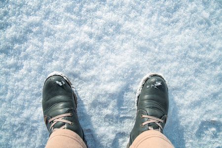 Top view. Feet in winter boots on fresh white snow. Winter Conceptの写真素材