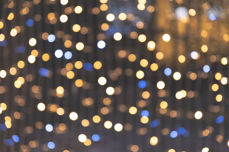 defocused shiny garland lights outdoors, winter holiday greeting card