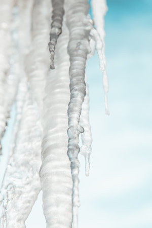 icicles on the background of the blue sky. Winter, frost