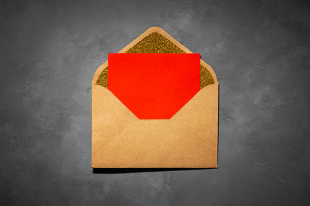 postcard, envelope with red paper inside, with copy space, on gray background. flat lay, top view, Love, Valentine's Day February 14, Weddingの写真素材