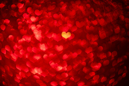 red background with heart-shaped highlights. beautiful holiday background, background for cards, congratulations on Valentine's Day, wedding dayの写真素材