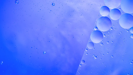 Abstract blue colorful background with oil on water surface. Oil drops in water abstract...