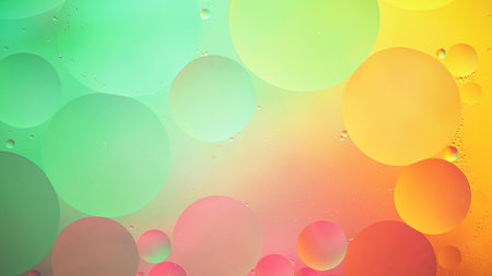 Abstract yellow, green and pink colorful background with oil on water surface. Oil drops in water abstract psychedelic, abstract image.の写真素材