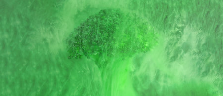 banner Fresh broccoli in cloud of green color paint in water. Artistic nutrition concept. Science of food action photography. Creative concept of vegetarianism, benefits of vegetablesの写真素材