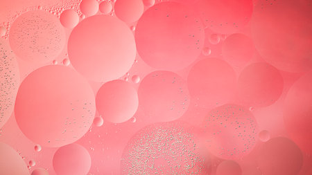 Abstract pink colorful background with oil on water surface. Oil drops in water abstract psychedelic, abstract image.の写真素材