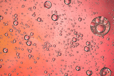 Abstract pink colorful background with oil on water surface. Oil drops in water abstract psychedelic, abstract image.の写真素材