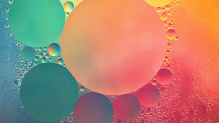 Abstract yellow, green and pink colorful background with oil on water surface. Oil drops in water abstract psychedelic, abstract image.の写真素材