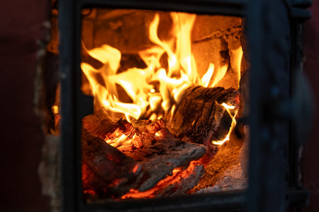 The fire burns in the stove. firewood, warmth, comfort, observationの写真素材