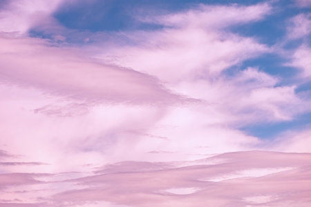 Magic pink cumulus clouds in blue sky, sunset, sunrise, nature background, wallpaper