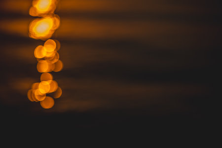 blurred background, sunset or sunrise on the sea, a path of light on the water on dark sea...