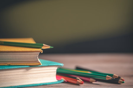 Books, stationery lie on the table against the background of a black chalkboard. Education, September 1, new academic yearの写真素材