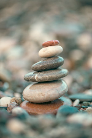 A pyramid of stones on a pebble beach by the sea, the concept of balance, balance, tranquility,...