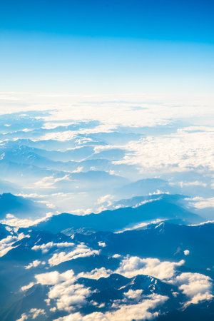 A view of the planet Earth, a view from an airplane, mountains and cloudsの写真素材
