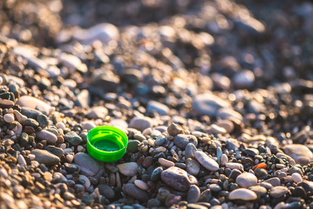 plastic bottle cap on the beach, environmental pollution