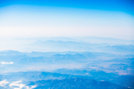 A view of the planet Earth, a view from an airplane, mountains and cloudsの写真素材