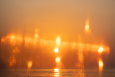 Beautiful sunset or sunrise on the sea, clear sky, natural delicate background with beautiful highlights, sky and sun at sunriseの写真素材