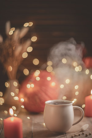 Autumn cozy composition. Tea in a mug, pumpkins and candlesの写真素材