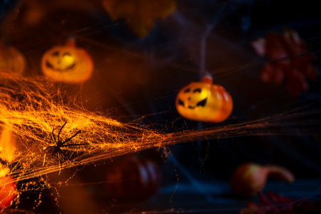 Halloween. crawl spiders on the web. Garland with orange pumpkinsの写真素材
