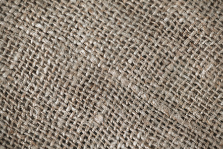 Close up background, natural craft brown linen fabric, thread weave, textile texture, perfect for backgrounds, textiles, wallpapersの写真素材