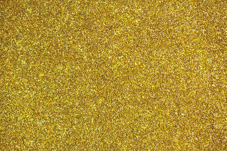 Shiny gold glitter background, sparkling texture, perfect for backgrounds, textiles, wallpapersの写真素材