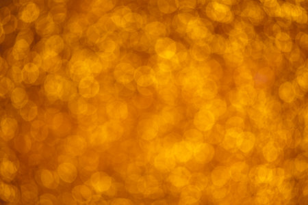 Shiny gold glitter background, blurry sparkling lights texture, perfect for backgrounds, textiles, wallpapersの写真素材
