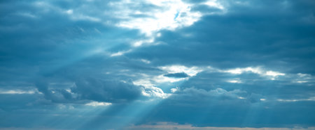 beautiful white cumulus clouds in blue sky, natural background, wallpaper, sun rays through cloudsの写真素材