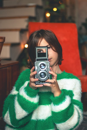 Cute teen girl holding retro camera, vintageの写真素材