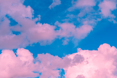 Magic pink fabulous cumulus clouds on blue sky at sunrise sunset nature background wallpaperの写真素材