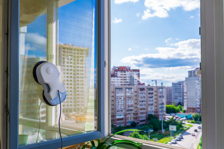Robot window cleaner washes glass with round rags, robotic service, modern technologies