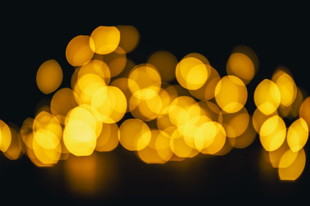background, texture. Yellow round bokeh on black backgroundの写真素材