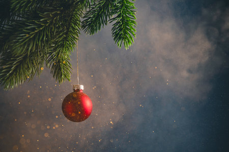 A red Christmas ball in clouds of smoke and glitter. New Year, Christmasの写真素材