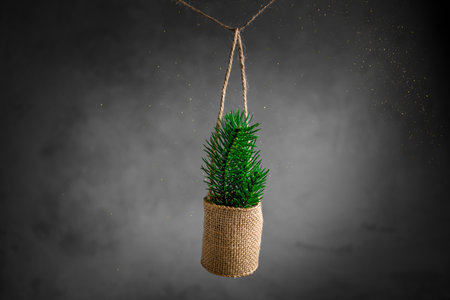 New Year's Eve, Christmas composition. spruce branches in a canvas bag on a gray background. gold sequinsの写真素材