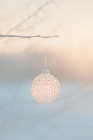 Christmas ball on tree outdoors, creative photo, new year, christmas. Color of the Year 2024 Peach Fuzz. Selective focus, beautiful phone screensaverの写真素材