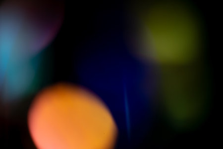 Multicolored bright highlights on a black background. for overlay to create a festive, vibrant effect, abstract backgroundの写真素材
