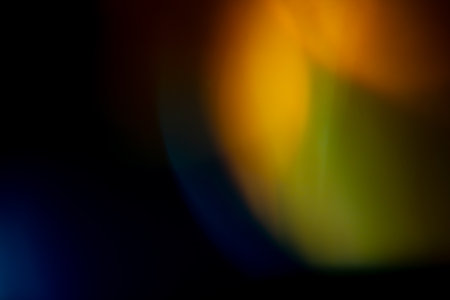 orange golden warm bright highlights on a black background. for overlay to create effect of sun rays on a bright day, warm, cozy atmosphereの写真素材