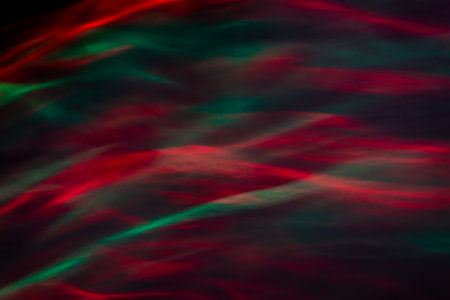 Defocused abstract red and green background of speed camera movement over glowing lights. A pattern...