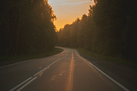 The asphalt road goes into the distance On the Sunsetの写真素材