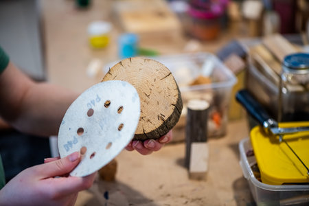 cute teen girl at a master class making a craft from wood, exhibition of crafts, crafts fair, education, master classes, DIY wood productの写真素材