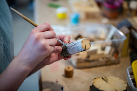cute teen girl at a master class making a craft from wood, exhibition of crafts, crafts fair, education, master classes, DIY wood productの写真素材