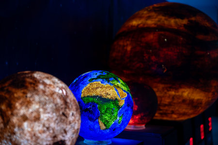 The illuminated globe and other planets provide a stunning glimpse into the beauty and complexity of the solar system.の写真素材