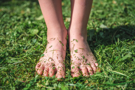 The concept of summer, ecology. unity with nature. bare feet in the grassの写真素材