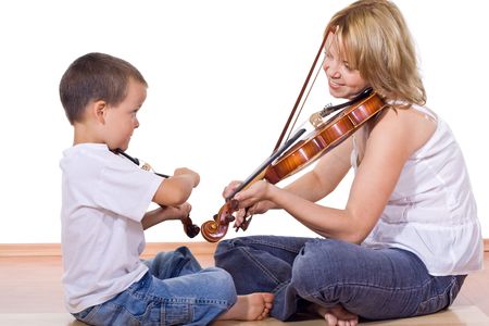 Little boy and woman sitting on the floor practicing the violin - isolatedの写真素材