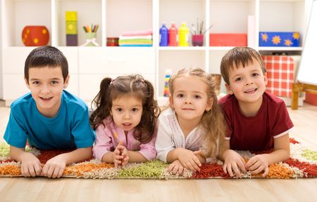 Kids in their room ready for their closeup - posing laying on the floorの写真素材