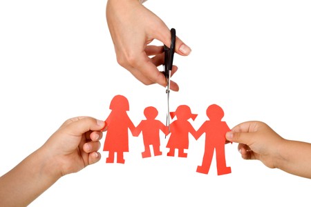 Divorce effect on kids concept with hands cutting paper people family - isolatedの写真素材
